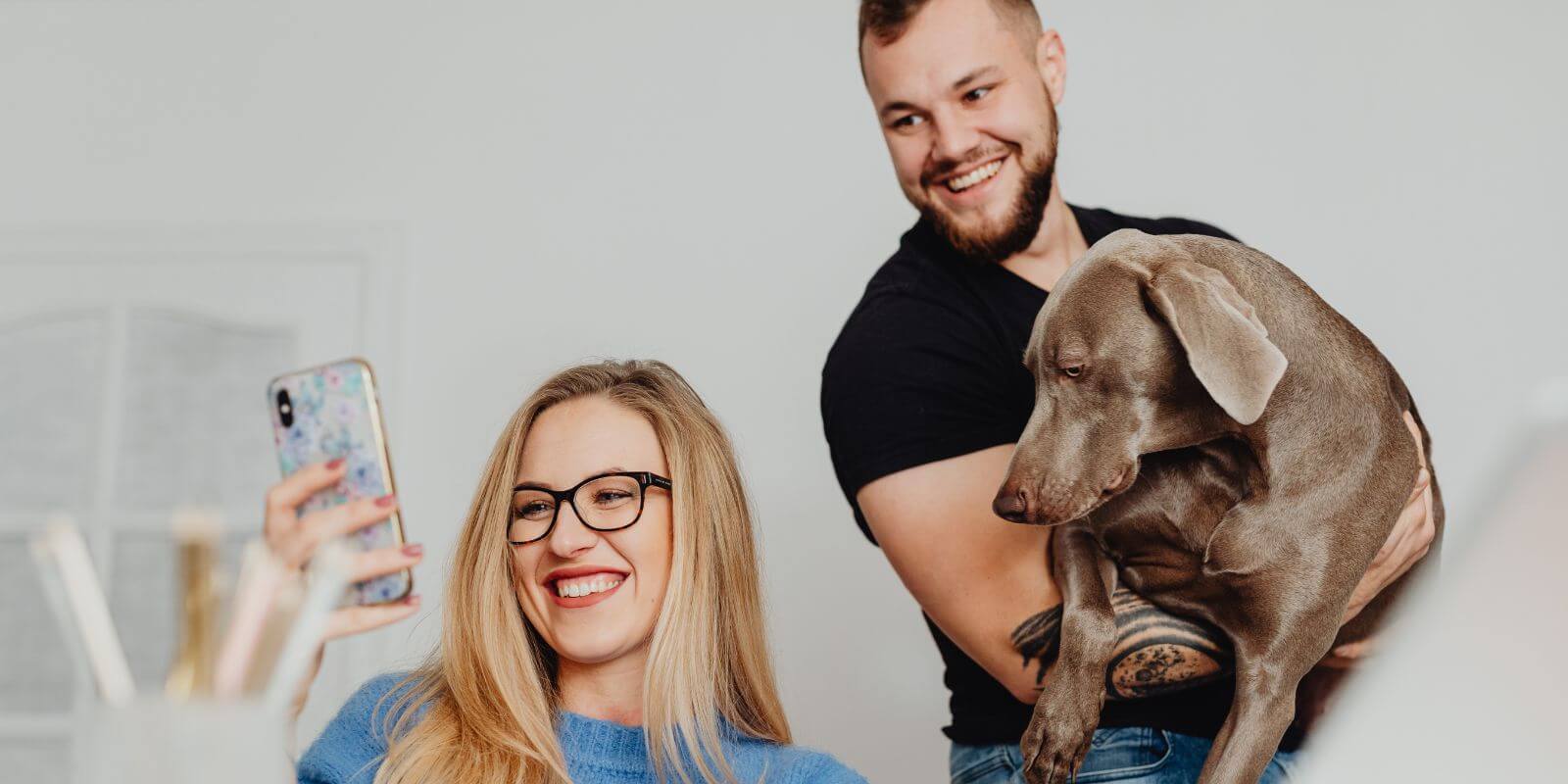 Couple searching how to get pet insurance holding their beautiful dog