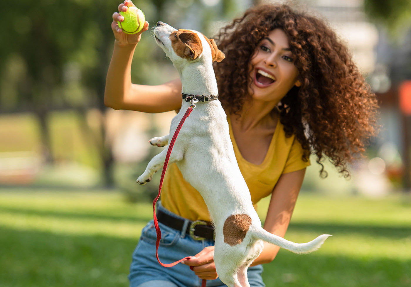 woman playing with her newly insured dog